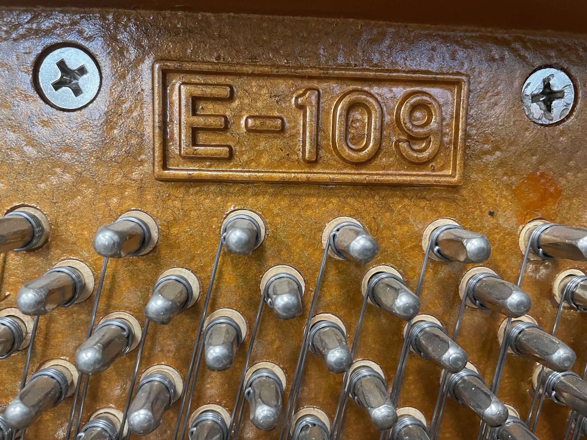 Close-up of E-109 piano serial number.