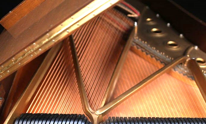 Close-up of Steinway piano strings and frame inside.