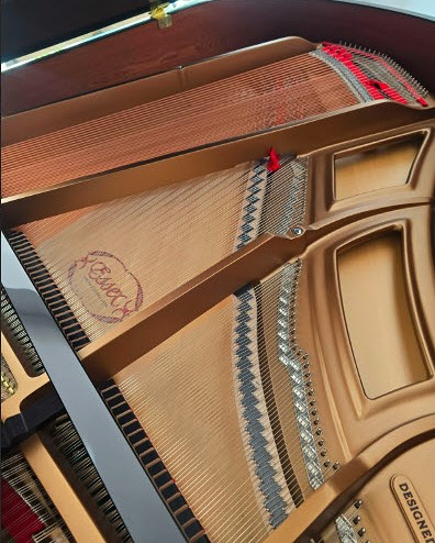 Essex Grand piano interior with strings and hammers visible.