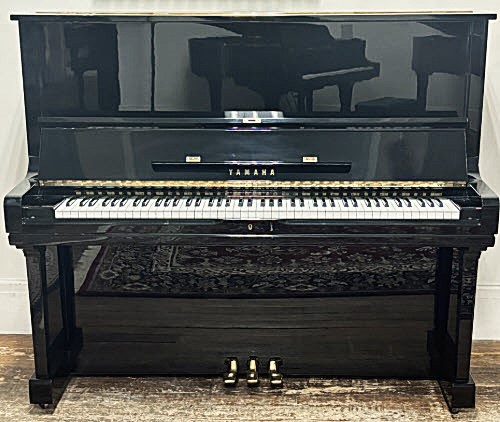 Black Yamaha upright piano with polished finish