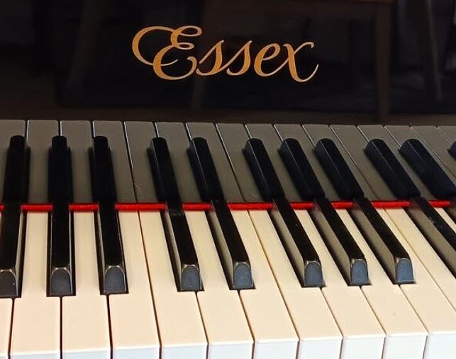 Close-up of Essex piano keys and logo.